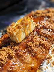 Image showing Close-up view of delicious juicy meat with ribs on grill