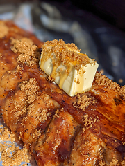 Image showing Close-up view of delicious juicy meat with ribs on grill