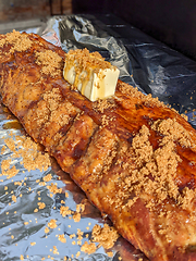 Image showing Close-up view of delicious juicy meat with ribs on grill