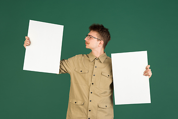 Image showing Caucasian man\'s portrait isolated over green studio background with copyspace