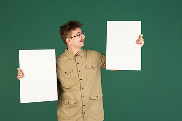 Image showing Caucasian man\'s portrait isolated over green studio background with copyspace