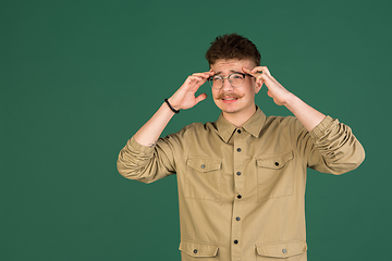 Image showing Caucasian man\'s portrait isolated over green studio background with copyspace