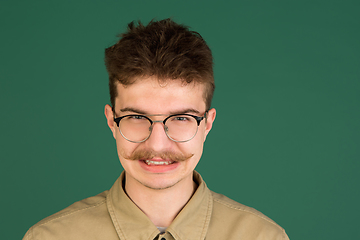 Image showing Caucasian man\'s portrait isolated over green studio background with copyspace