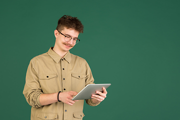 Image showing Caucasian man\'s portrait isolated over green studio background with copyspace