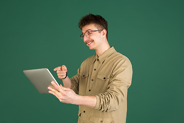 Image showing Caucasian man\'s portrait isolated over green studio background with copyspace