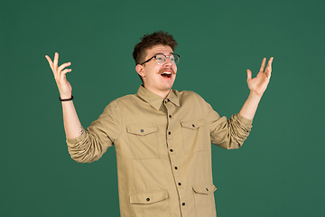 Image showing Caucasian man\'s portrait isolated over green studio background with copyspace