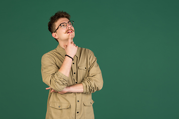 Image showing Caucasian man\'s portrait isolated over green studio background with copyspace