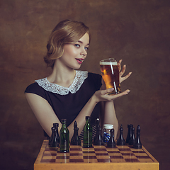 Image showing Young woman in art action isolated on brown background. Retro style, comparison of eras concept.