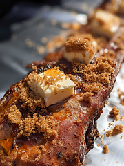 Image showing Close-up view of delicious juicy meat with ribs on grill