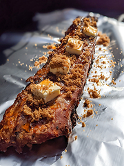 Image showing Close-up view of delicious juicy meat with ribs on grill