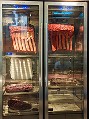 Image showing Dry aged beef steaks - ribeye, striploin, t-bone steaks on Black