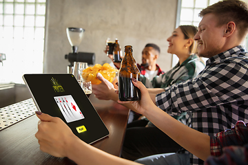 Image showing Group of friends watching sport match together. Emotional fans cheering for favourite team, watching on exciting game. Concept of friendship, leisure activity, emotions