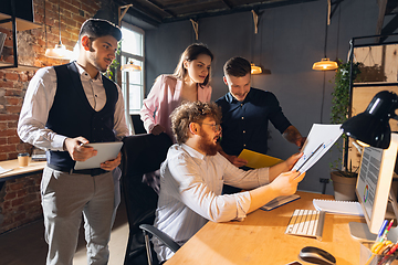 Image showing Colleagues working together in modern office using devices and gadgets during creative meeting