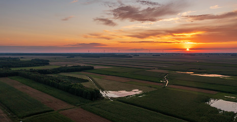 Image showing Colorful sunset over forest and fields aerial