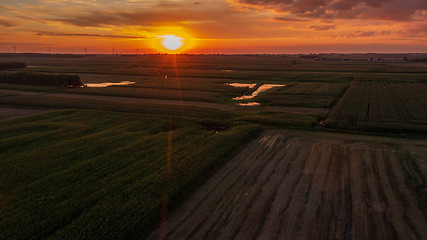 Image showing Colorful sunset over forest and fields aerial