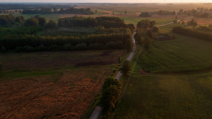 Image showing Colorful sunset over forest and fields aerial