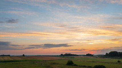 Image showing Colorful sunset over forest and fields aerial