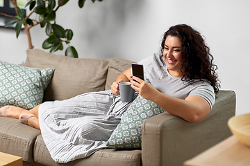 Image showing woman with smartphone drinking coffee at home