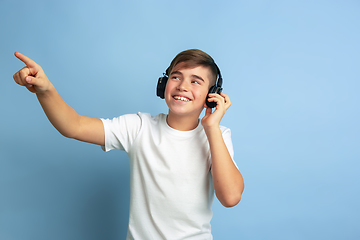 Image showing Caucasian teen\'s portrait isolated on blue studio background