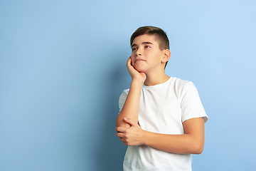 Image showing Caucasian teen\'s portrait isolated on blue studio background