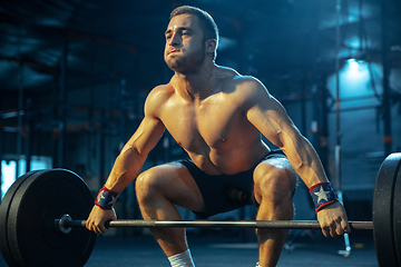 Image showing Caucasian man practicing in weightlifting in gym