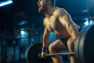 Image showing Caucasian man practicing in weightlifting in gym