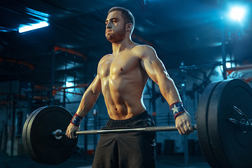 Image showing Caucasian man practicing in weightlifting in gym