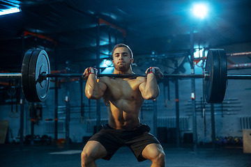 Image showing Caucasian man practicing in weightlifting in gym