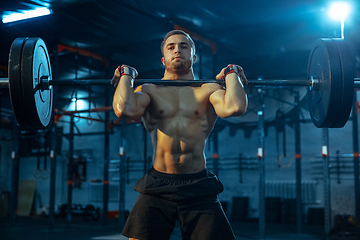 Image showing Caucasian man practicing in weightlifting in gym