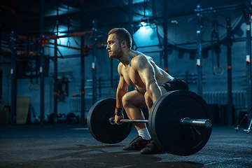 Image showing Caucasian man practicing in weightlifting in gym