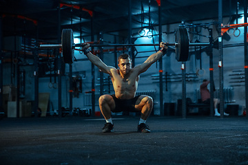 Image showing Caucasian man practicing in weightlifting in gym