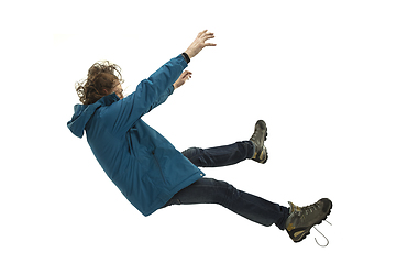 Image showing A second before falling - young man falling down with bright emotions and expression