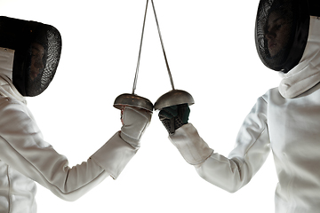 Image showing Teen girls in fencing costumes with swords in hands isolated on white background