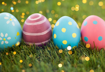 Image showing row of colored easter eggs on artificial grass