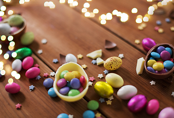 Image showing chocolate eggs and candy drops on wooden table