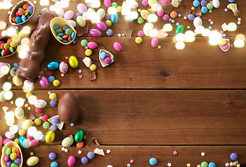 Image showing chocolate eggs, easter bunny and candies on wood