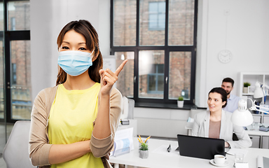 Image showing asian woman in protective medical mask at office