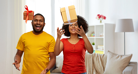 Image showing happy african american couple throwing gift boxes