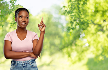 Image showing happy african american woman pointing finger up