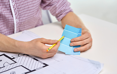 Image showing architect with blueprint and color palettes