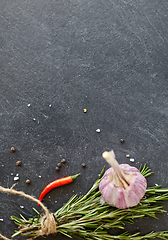 Image showing rosemary, garlic and chili pepper on stone surface