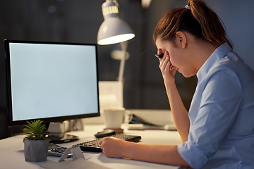 Image showing stressed businesswoman with computer at night