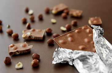 Image showing milk chocolate bar with hazelnuts in foil wrapper