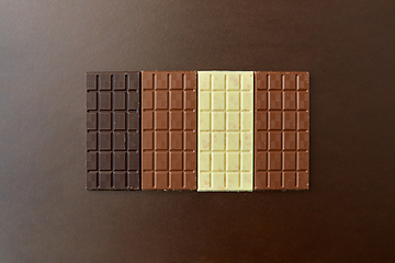 Image showing different kinds of chocolate on brown background