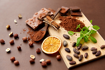 Image showing chocolate with hazelnuts, cocoa beans and powder