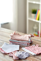 Image showing baby clothes on wooden table at home