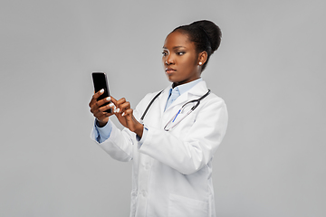 Image showing african american female doctor with smartphone