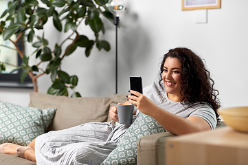 Image showing woman with smartphone drinking coffee at home