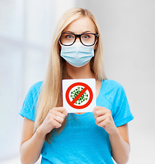 Image showing woman in medical mask holding coronavirus sign