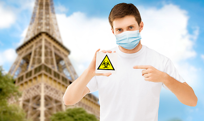 Image showing man in mask with biohazard sign in france